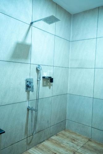 a shower with a phone in a bathroom at Casino Hotels Ltd in Trichūr