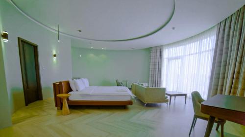 une chambre avec un lit, une table et une fenêtre dans l'établissement Gorgora Eco Resort By Ethiopian Skylight, à Gorgora