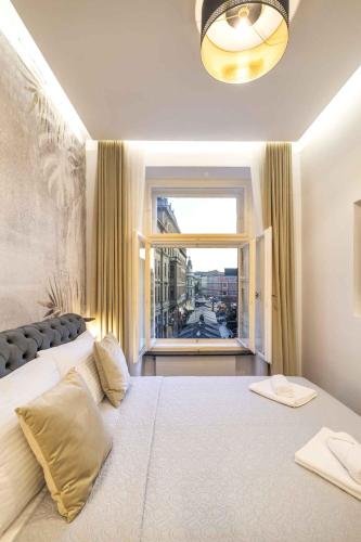 a bedroom with a large bed with a large window at ZAGABRIA - Modern Boutique Studios by Main Square in Zagreb