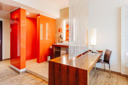 a bathroom with a desk and a sink in it at Das Seepark Wörthersee Resort in Klagenfurt