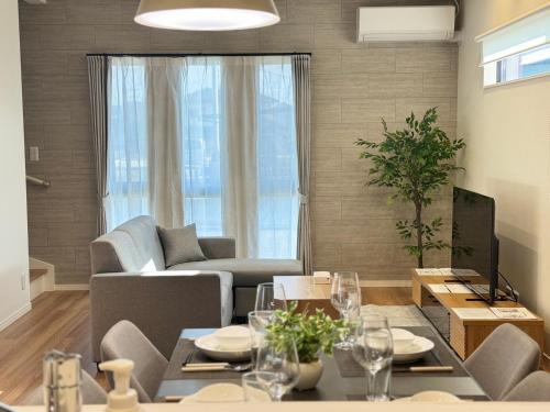 a living room with a couch and a table at Akikawa Waifu 1 in Kikuchi