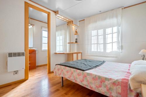 a bedroom with a bed and two windows at La Marquesa in Camarles
