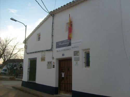 a white building with a sign on the side of it at Señorío de Monterruiz in Casas de Santa Cruz