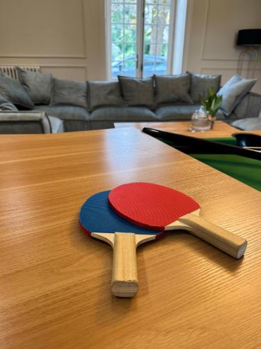two ping pong paddles on top of a wooden table at Domaine Labattut in Saint-Astier