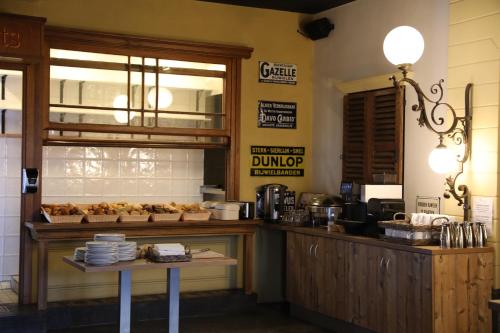 a bakery with a counter with pastries on it at Hotel Courage Nijmegen in Nijmegen