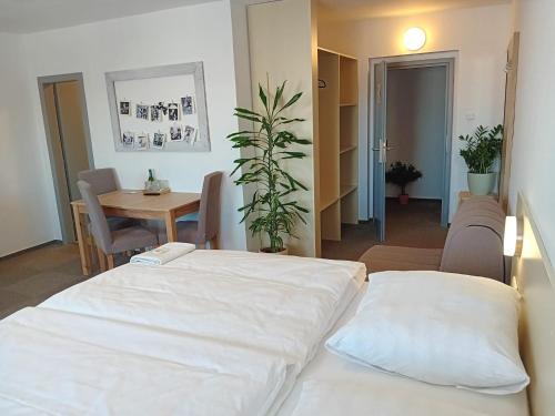 a room with a bed and a table and a tableablish at Hotel u Budvaru in České Budějovice