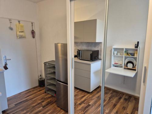 a small kitchen with a refrigerator and a microwave at Relax CENTER in Frankfurt/Main