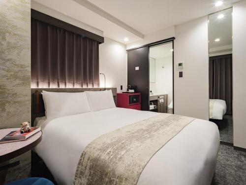 Una cama o camas en una habitación de the b ginza