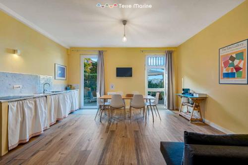 a kitchen and dining room with a table and chairs at Twilight, Terre Marine in Lerici