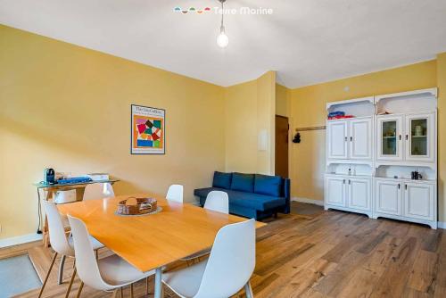 a dining room with a table and a blue couch at Twilight, Terre Marine in Lerici