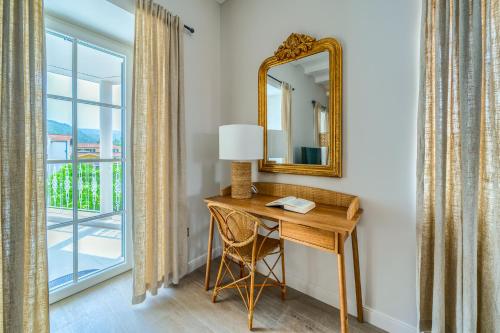 a desk in a room with a mirror and a window at Hotel Brattia, Adults Only, Heated Pool, A la Carte Breakfast, Postira, Brač Island in Postira