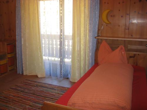 a bedroom with a bed and a large window at Villa Emilia in Kals am Großglockner