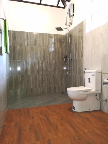 a bathroom with a toilet and a shower at Abhimani Bungalows in Aluthgama