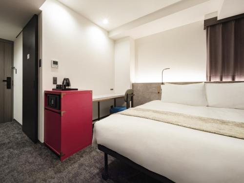 Una cama o camas en una habitación de the b ginza