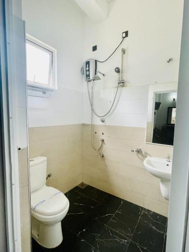 a bathroom with a toilet and a sink at Thinaya Lake Resort in Anuradhapura