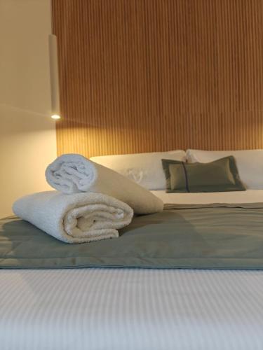 a bed with two towels on top of it at Lilla Suites - Musei Vaticani in Rome