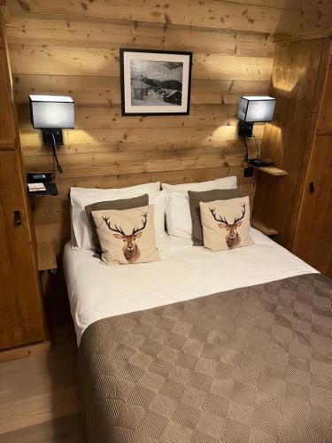a bedroom with a bed with two deer heads on the pillows at Arc 1950 Ski in Ski out and Spa- Newly refurbished 153 Sources De Marie- 2 bedroom , 2 bathroom-Sleeps 4-6, Mont Blanc view from every window, Free WiFi in Arc 1950