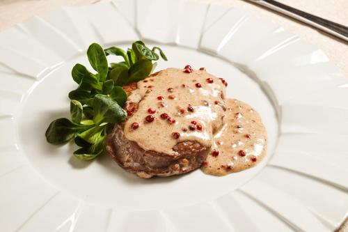 a white plate with a piece of food on it at Hotel Mastrodattia in Celano
