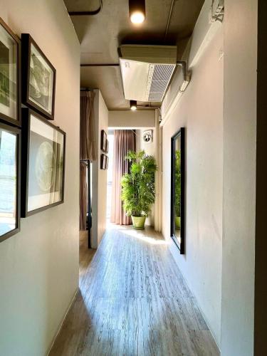 a hallway of a house with a plant in it at Collection O The Spades Hostel in Bangkok