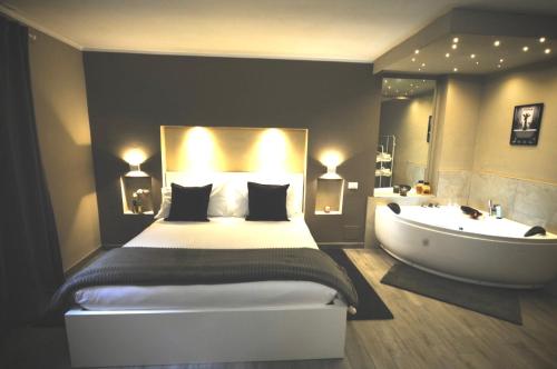 a bedroom with a bed and a bathtub and a bed and a sink at Europa APT - Dolcevita Holiday in Florence