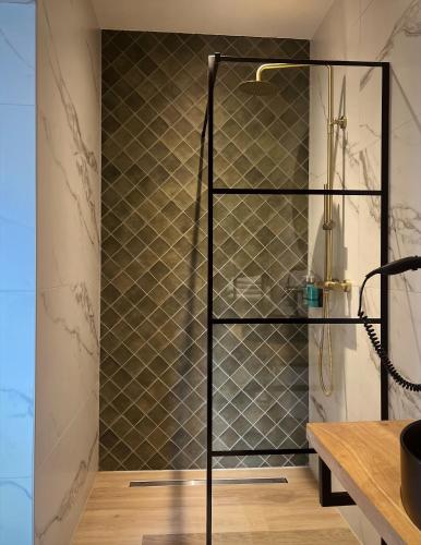 a shower with a glass door in a bathroom at Hotel La Boutique in Nijmegen