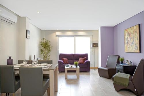 a living room with a table and a dining room at Alpujarra Secret by eme hoteles in Órgiva