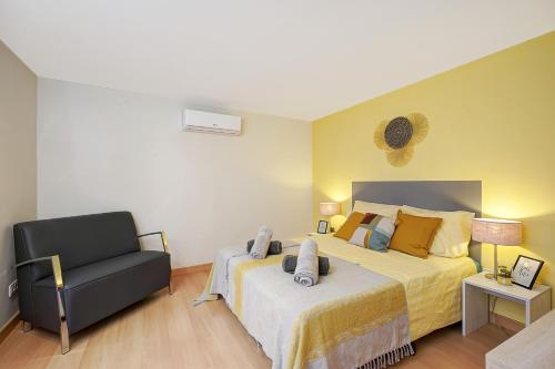 a bedroom with a large bed and a chair at Alpujarra Secret by eme hoteles in Órgiva