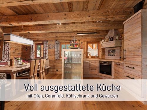a kitchen with a refrigerator and a table with chairs at Chalet am Oberhausberg, Region Schladming Dachstein in Haus im Ennstal