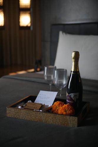a bottle of wine and two glasses on a table at INSPIRA Seminyak in Seminyak