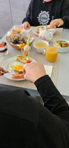 een groep mensen die aan een tafel zitten en eten bij Happy House - Marina Centro in Rimini