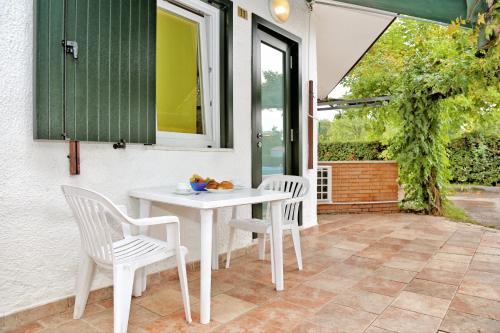 a white table and two chairs on a patio at Camping Cisano - San Vito in Bardolino