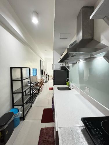 a kitchen with a counter and a sink in it at Beach condos at Pico de Loro Cove - Wi-Fi & Netflix, 42-50''TVs with Cignal cable, Uratex beds & pillows, equipped kitchen, balcony, parking - guest registration fee is not included in Nasugbu