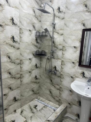 a bathroom with a shower and a sink at Cornicello guest haus in Tbilisi City