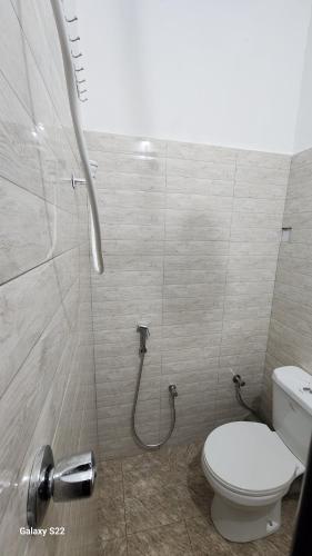 a bathroom with a toilet and a shower at Mardai Homestay in Arusha