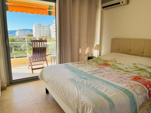 - une chambre avec un lit et un balcon avec une chaise dans l'établissement Croisette and beaches. View on gardens and sea., à Cannes