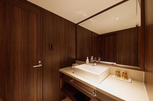 a bathroom with a white sink and a mirror at Kyoto Century Hotel in Kyoto