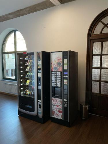 two vending machines are sitting next to a wall at Casa Diocesana VIA LUCIS in Santiago de Compostela