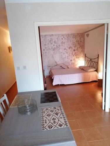 une chambre avec un lit et une table dans une pièce dans l'établissement Aux Papyrus, à La Londe-les-Maures