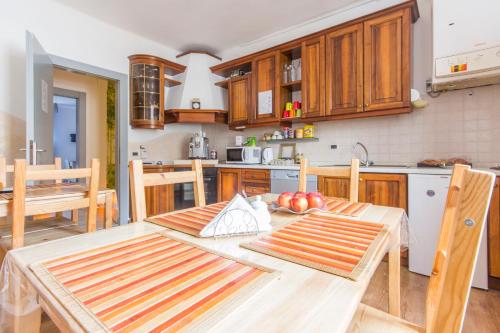 a kitchen with a wooden table and wooden cabinets at Bed & Breakfast Nettuno in Trento