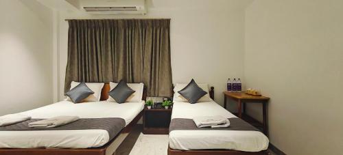Katil atau katil-katil dalam bilik di Woodlands Inn