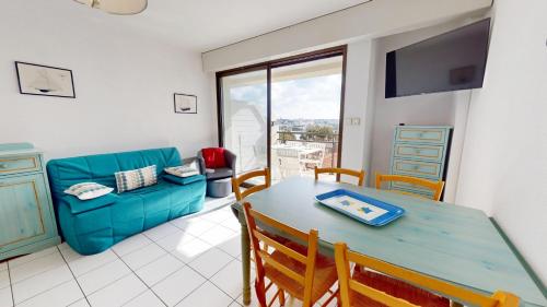 un salon avec une table et un canapé dans l'établissement Le Corsaire Face Mer, à Saint-Gilles-Croix-de-Vie