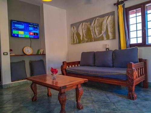 a living room with a couch and a coffee table at Modern Girasoli Suites 01 in Malindi