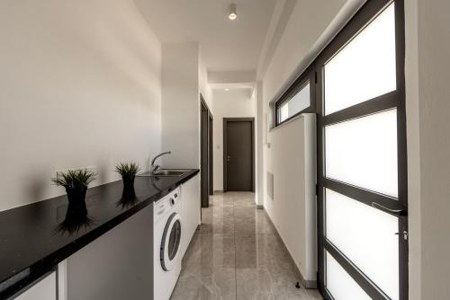 a laundry room with a sink and a window at Diamond villas in Protaras