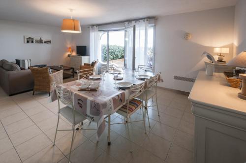 une salle à manger et un salon avec une table et des chaises dans l'établissement appartement dans une residence en front de mer - 4910, à Soulac-sur-Mer