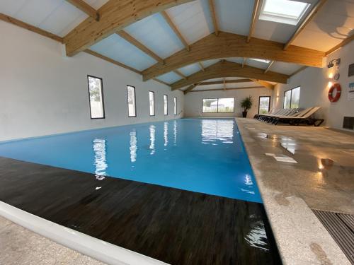 une piscine intérieure d'eau bleue dans un bâtiment dans l'établissement Chalet pour 6 à St-Hilaire - Piscine chauffée, à Saint-Hilaire-de-Riez