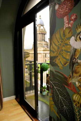 a room with a window with a view of a building at Heart of Leeds - 2 Bedroom Flat in Leeds
