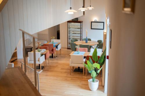a restaurant with tables and chairs and a staircase at Casa da Fonte de Cima in Celorico de Basto