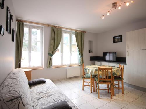 un salon avec une table et une cuisine dans l'établissement Appartement F2 bis, 50m², centre Mont-Dore, wifi, tout équipé, animaux acceptés - FR-1-415-132, à Le Mont-Dore
