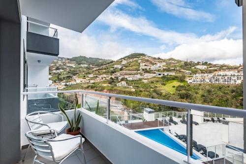 a balcony with a view of a city at Refúgio Girassol in Caniço