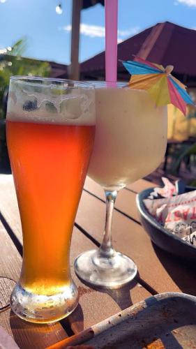 two glasses of beer sitting on top of a table at Hotel Centro vacacional El Cielo in Rivera